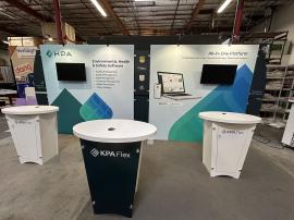 RENTAL: RE-2139 Sunrise Portable 10’ x 20’ Inline Design with (2) 7.5 ft. Wide x 7.5 ft. High Extrusion Frames, Baseplates, (2) Monitor Mounts, (4) LED Arm Lights, (3) RE-1201 Reception Counters, SEG Fabric Graphics, Direct Print Sintra Graphic Panels